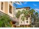 Exterior daytime view of The Madison building featuring distinct architecture, signage, and lush tropical landscaping at 200 4Th S Ave # 127, St Petersburg, FL 33701