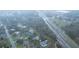 Wide aerial view of the surrounding area with a road and pond at 20004 Harvie Ln, Lutz, FL 33558