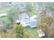 An aerial view of a home and lot, surrounded by trees at 20004 Harvie Ln, Lutz, FL 33558