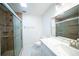 Bathroom with glass shower, toilet, white vanity with mirror and overhead lighting at 20004 Harvie Ln, Lutz, FL 33558