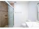 Bathroom featuring tiled walk-in shower, white walls, tile floors, and chrome fixtures at 20004 Harvie Ln, Lutz, FL 33558