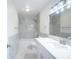 A bright and airy bathroom is equipped with marble-look tile and a tub at 20004 Harvie Ln, Lutz, FL 33558