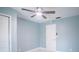 A calming bedroom with a ceiling fan and a closet is awash in light blue at 20004 Harvie Ln, Lutz, FL 33558