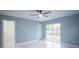 This bedroom has a walk-in closet, a sliding glass door, and tile floors at 20004 Harvie Ln, Lutz, FL 33558