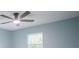 This bedroom has light blue walls and a ceiling fan near a window at 20004 Harvie Ln, Lutz, FL 33558