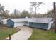 Quaint single Gathering home with lush green lawn and a long, paved driveway at 20004 Harvie Ln, Lutz, FL 33558