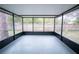 Screened lanai offers an outdoor living space with views of the backyard at 20004 Harvie Ln, Lutz, FL 33558