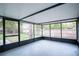 Enclosed lanai provides a shady spot with view of fenced backyard and mature trees at 20004 Harvie Ln, Lutz, FL 33558