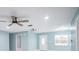 Bright living room features modern ceiling fan, updated lighting, and fresh paint at 20004 Harvie Ln, Lutz, FL 33558