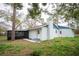 Exterior view of a home featuring a spacious screened-in porch at 20004 Harvie Ln, Lutz, FL 33558