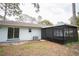 Exterior of home with a screened-in porch and sliding glass door at 20004 Harvie Ln, Lutz, FL 33558