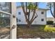 Exterior view of the home from the backyard with mature trees at 211 Brandy Wine Dr # 211, Largo, FL 33771