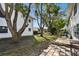 Backyard featuring mature trees, lush green lawn and brick patio at 211 Brandy Wine Dr # 211, Largo, FL 33771