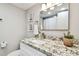 Bright bathroom featuring a granite countertop, stylish mirror and decor at 211 Brandy Wine Dr # 211, Largo, FL 33771