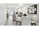 Bright dining area with a glass table and white chairs, adjacent to the kitchen at 211 Brandy Wine Dr # 211, Largo, FL 33771