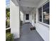 Inviting condo entrance with a modern white exterior and manicured landscaping at 211 Brandy Wine Dr # 211, Largo, FL 33771