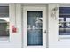 Condo entrance features a screen door, fire alarm, and door number at 211 Brandy Wine Dr # 211, Largo, FL 33771