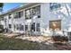 A charming exterior view with a tiled patio seating area and large windows at 211 Brandy Wine Dr # 211, Largo, FL 33771