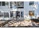 A charming exterior view with a tiled patio seating area and large windows at 211 Brandy Wine Dr # 211, Largo, FL 33771