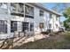 A charming exterior view with a tiled patio seating area and large windows at 211 Brandy Wine Dr # 211, Largo, FL 33771