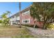 Two-story condo featuring a brick facade, lush landscaping, and inviting walkway at 211 Brandy Wine Dr # 211, Largo, FL 33771