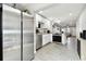 Open kitchen with stainless steel appliances, granite counters, and updated cabinetry at 211 Brandy Wine Dr # 211, Largo, FL 33771