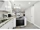 Bright kitchen boasts granite countertops, stainless steel range, and modern white cabinets at 211 Brandy Wine Dr # 211, Largo, FL 33771