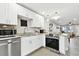 Updated kitchen features stainless appliances, white cabinetry, and granite countertops at 211 Brandy Wine Dr # 211, Largo, FL 33771