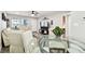 Combined living and dining area with a glass table and seating, connecting to the entry at 211 Brandy Wine Dr # 211, Largo, FL 33771