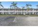 Exterior of condo complex with parking and lush landscaping with palm trees at 211 Brandy Wine Dr # 211, Largo, FL 33771