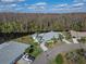 Stunning aerial perspective of a lakefront home with mature trees and beautifully maintained property at 2115 Hereford Dr, Sun City Center, FL 33573