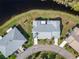 Stunning aerial view of home with lush green lawn and pond in the backyard at 2115 Hereford Dr, Sun City Center, FL 33573