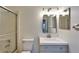 This bathroom features a vanity with a sink and storage, a shower with glass doors, and a toilet at 2115 Hereford Dr, Sun City Center, FL 33573