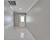 Entryway featuring white patterned tile flooring, white wainscoting and a front door with decorative glass at 2115 Hereford Dr, Sun City Center, FL 33573