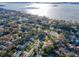 Scenic aerial view of a residential neighborhood with tree-lined streets near the bay at 220 Garden S Cir, Dunedin, FL 34698