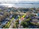 Aerial shot of the home, near a body of water, surrounded by lush landscaping and trees at 220 Garden S Cir, Dunedin, FL 34698