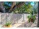 Scenic backyard with a view of mature trees and plants, and a partial view of the home's exterior at 220 Garden S Cir, Dunedin, FL 34698