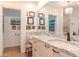 Bathroom boasts granite counters, framed mirrors, modern fixtures, and a tiled walk-in shower at 220 Garden S Cir, Dunedin, FL 34698