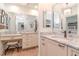 Bathroom featuring dual sink vanity, granite counters, framed mirrors, modern fixtures, and a walk-in shower at 220 Garden S Cir, Dunedin, FL 34698