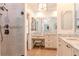 Bathroom boasts granite counters, framed mirrors, modern fixtures, and a tiled walk-in shower at 220 Garden S Cir, Dunedin, FL 34698