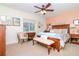 Cozy bedroom with a wooden bed, decorative pillows, a window with blinds, and warm, inviting decor at 220 Garden S Cir, Dunedin, FL 34698