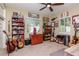 Eclectic bedroom with guitars, memorabilia, and natural light from the windows creating a unique space at 220 Garden S Cir, Dunedin, FL 34698
