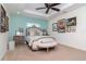 Spacious bedroom with neutral carpet and a variety of tasteful artwork on the walls at 220 Garden S Cir, Dunedin, FL 34698