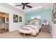 Comfortable bedroom with tray ceiling, complemented by tasteful decorations and an ensuite bathroom at 220 Garden S Cir, Dunedin, FL 34698