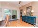 Sunlit dining area with sliding glass doors and stylish blue dresser at 220 Garden S Cir, Dunedin, FL 34698