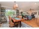 Open-concept dining area with woven chairs, wood table, and view to the living room at 220 Garden S Cir, Dunedin, FL 34698