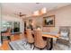 Inviting dining room with hardwood floors, a wooden table, woven chairs, and stylish decor at 220 Garden S Cir, Dunedin, FL 34698