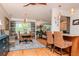 Open-concept dining area with stylish seating and a view to the kitchen at 220 Garden S Cir, Dunedin, FL 34698