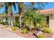 Beautiful one-story home boasts a lushly landscaped front yard, and covered entryway with columns at 220 Garden S Cir, Dunedin, FL 34698