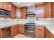 Kitchen with stainless steel appliances, wooden cabinets, and modern backsplash at 220 Garden S Cir, Dunedin, FL 34698